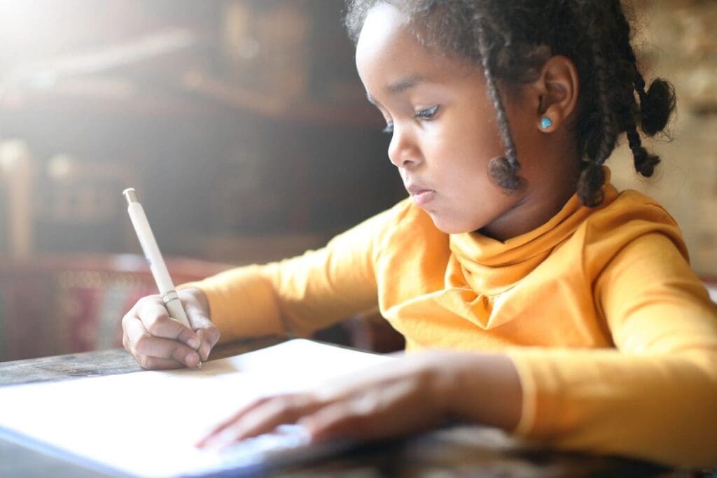 child in school writing